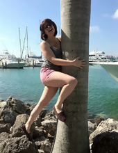 Big-tittied girl takes pictures on the beach and in the cafe