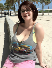 Big-tittied girl takes pictures on the beach and in the cafe