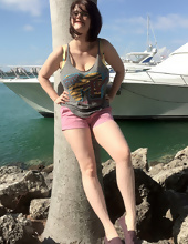 Big-tittied girl takes pictures on the beach and in the cafe