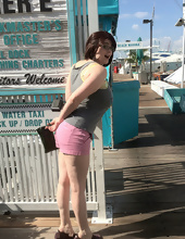 Big-tittied girl takes pictures on the beach and in the cafe