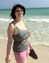 Big-tittied girl takes pictures on the beach and in the cafe