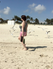 Big-tittied girl takes pictures on the beach and in the cafe