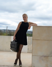 Blonde in stockings poses for solo pics at railway station