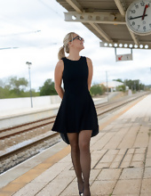 Blonde in stockings poses for solo pics at railway station