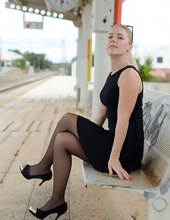 Blonde in stockings poses for solo pics at railway station