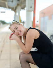 Blonde in stockings poses for solo pics at railway station