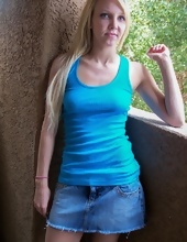 Blonde MILF in blue T-shirt and jean shorts exposes pussy