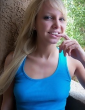 Blonde MILF in blue T-shirt and jean shorts exposes pussy