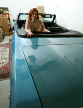 Shameless redhead in white stockings spreads legs in cool cabriolet