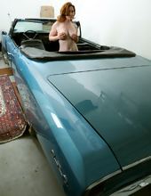 Shameless redhead in white stockings spreads legs in cool cabriolet