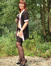 Dirty-minded MILF in sexy stockings and panties poses naked in park