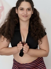 Cute girl in sexy outfit not shy to demonstrate her hairy pussy near wall