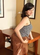 Long-legged brunette MILF showing her hairy snatch in the empty cabinet
