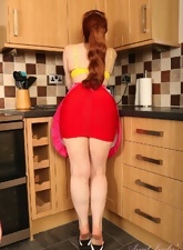 Mature redhead finds time to show her tits and wet pussy in the kitchen