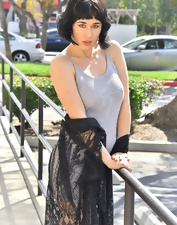 Dark-haired babe in sexy black shoes shows nude ass