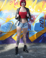 Total bimbo of a MILF toching her tits next to the wall