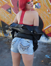 Total bimbo of a MILF toching her tits next to the wall