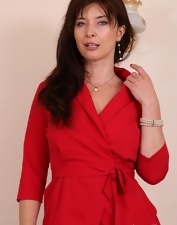 The stockings and the lingerie look very good on her MILF body