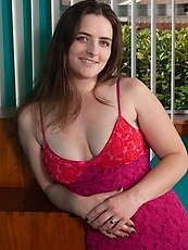 Sexy natural woman in red dress boasts about hairy pussy in pictures