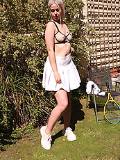 Tennis babe strips outdoors for a solo nude tease with natural tits and curvy booty