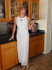 Elegant mature woman is fond of wine and expensive jewelry